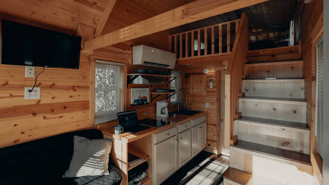 Room with wooden walls, furniture, and stairs