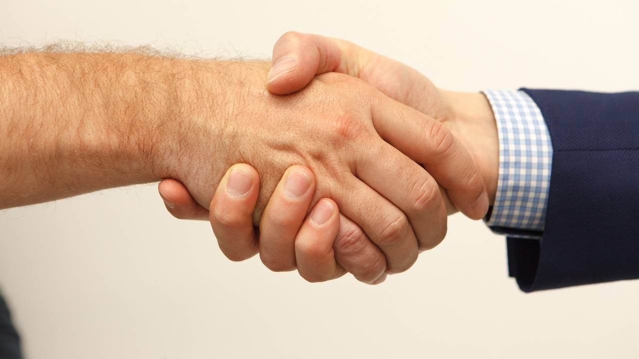 A firm handshake between two businessmen